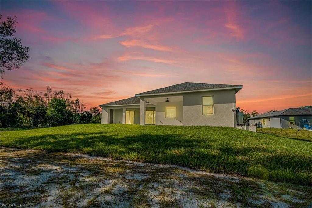 2941 37th Avenue Northeast Naples, FL 34120 - Photo 3 of 46 a front view of a house with garden