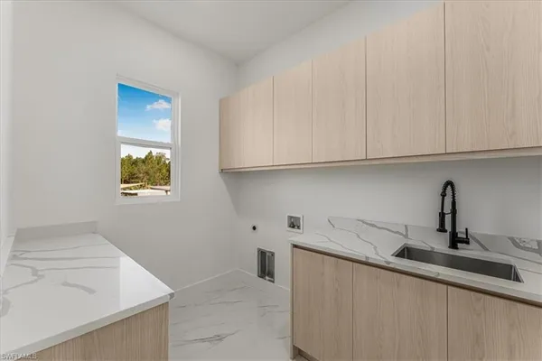 a large kitchen with stainless steel appliances a large counter top a refrigerator and a sink