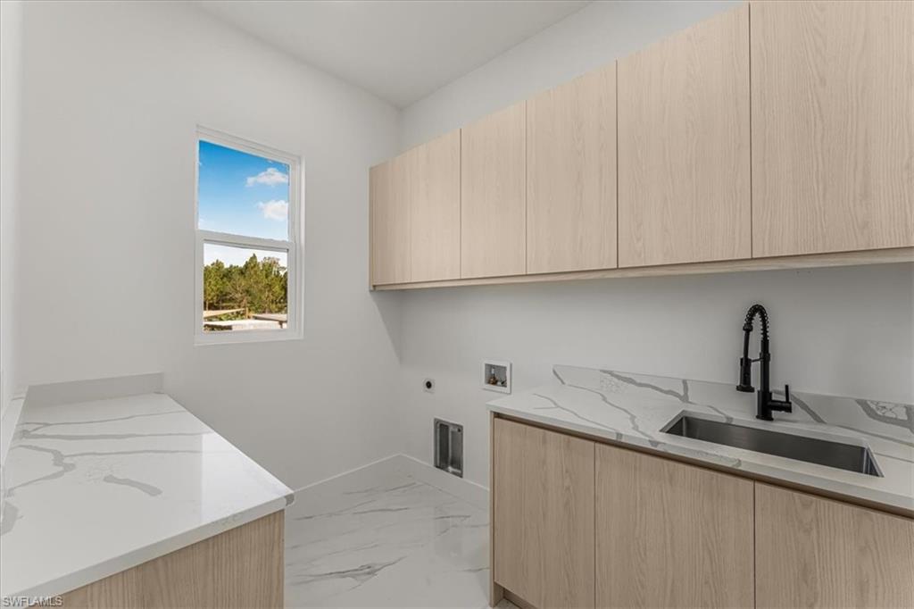 2941 37th Avenue Northeast Naples, FL 34120 - Photo 38 of 46 a kitchen with stainless steel appliances granite countertop white cabinets and a sink