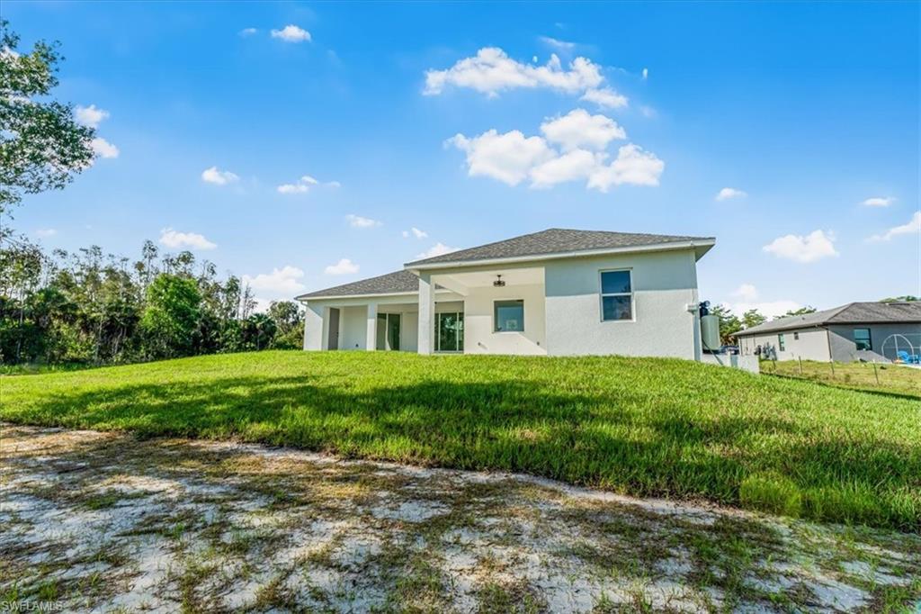 2941 37th Avenue Northeast Naples, FL 34120 - Photo 4 of 46 a view of a house with yard and a garden