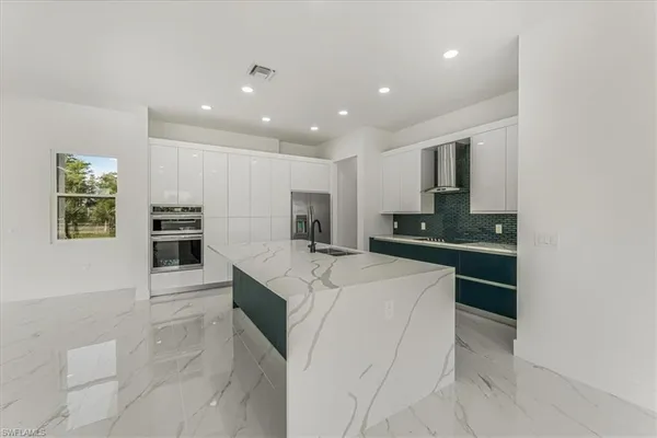 a view of kitchen with furniture and refrigerator