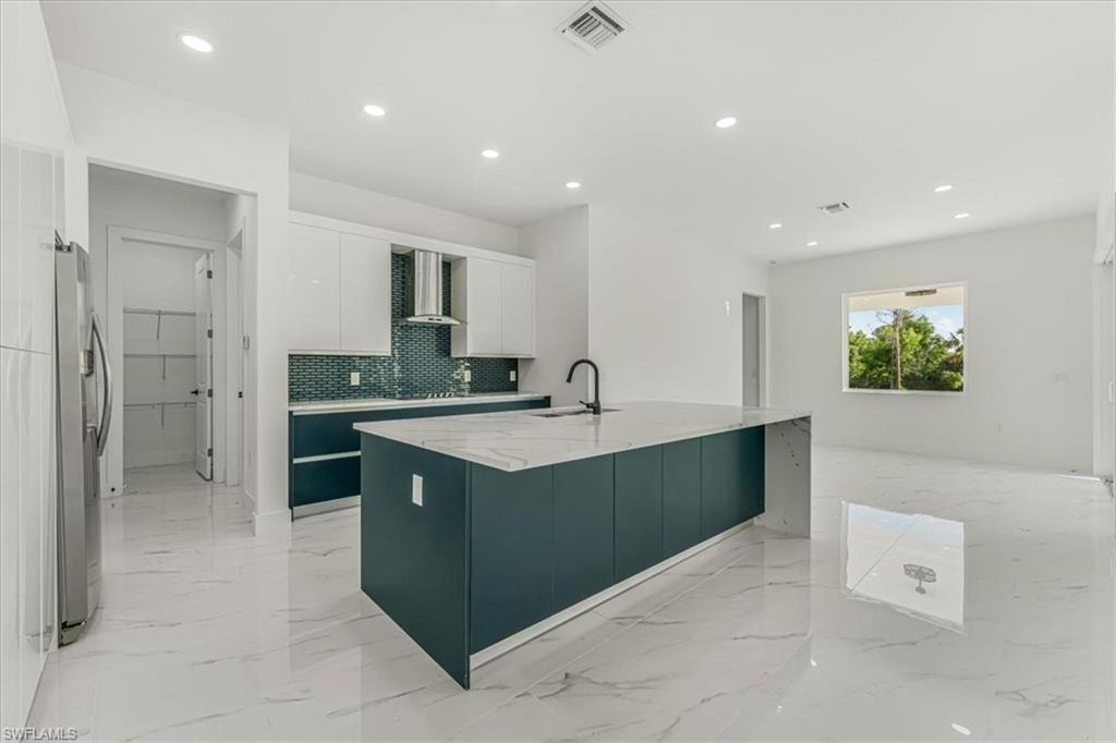 2941 37th Avenue Northeast Naples, FL 34120 - Photo 42 of 46 a kitchen with stainless steel appliances granite countertop a sink and a refrigerator