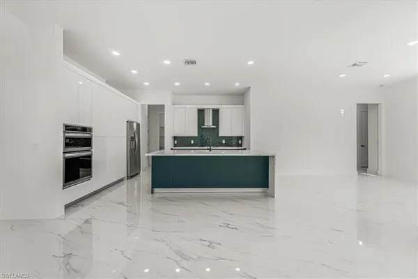 a view of kitchen with refrigerator and window