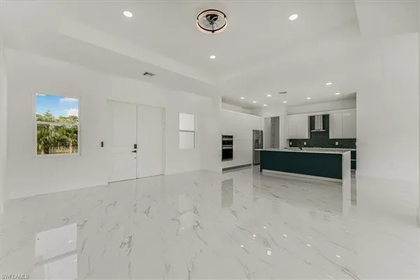 a view of a kitchen with a sink and a stove top oven