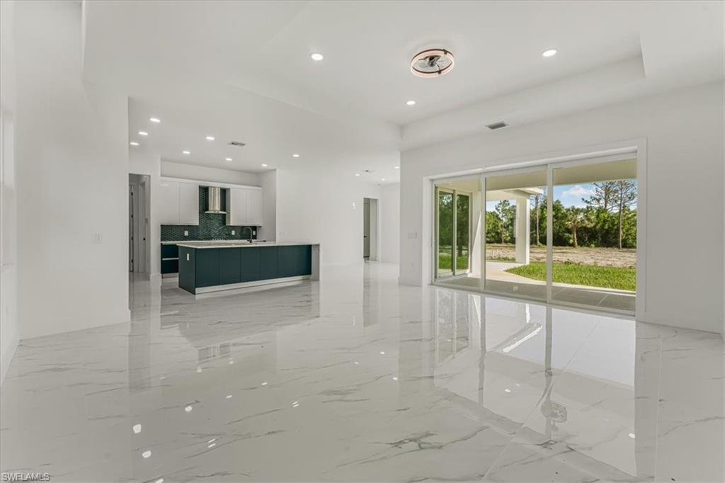2941 37th Avenue Northeast Naples, FL 34120 - Photo 45 of 46 a view of a kitchen with a sink and a stove top oven