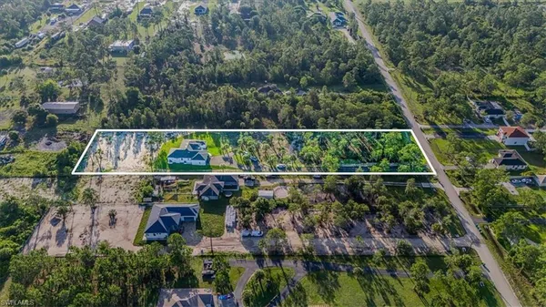 an aerial view of house with yard