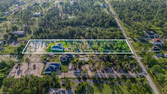 an aerial view of house with yard