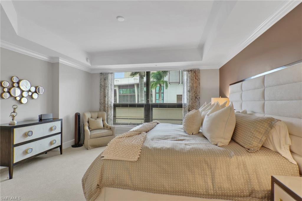 9123 Strada Place, Unit 7216 Naples, FL 34108 - Photo 10 of 28 Bedroom with carpet floors, crown molding, and a tray ceiling