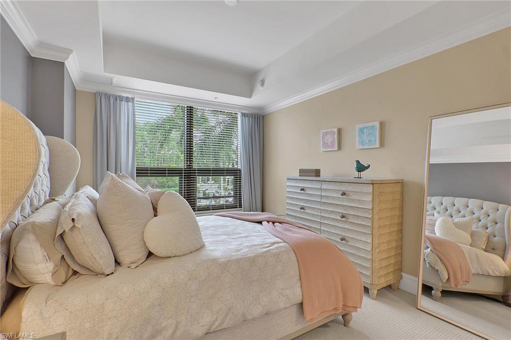 9123 Strada Place, Unit 7216 Naples, FL 34108 - Photo 12 of 28 Carpeted bedroom with crown molding and a tray ceiling