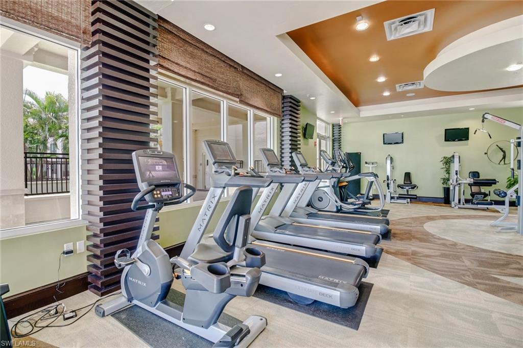 9123 Strada Place, Unit 7216 Naples, FL 34108 - Photo 22 of 28 Gym with a raised ceiling and recessed lighting