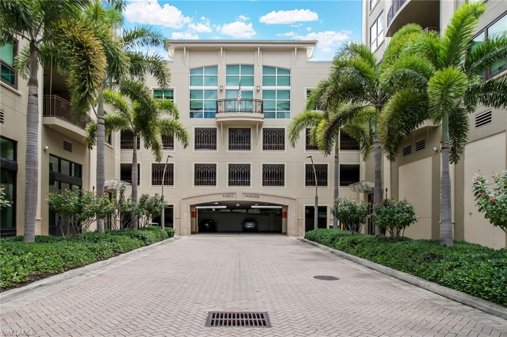 9123 Strada Place, Unit 7216 Naples, FL 34108 - Photo 27 of 28 View of building exterior with decorative driveway and an attached garage