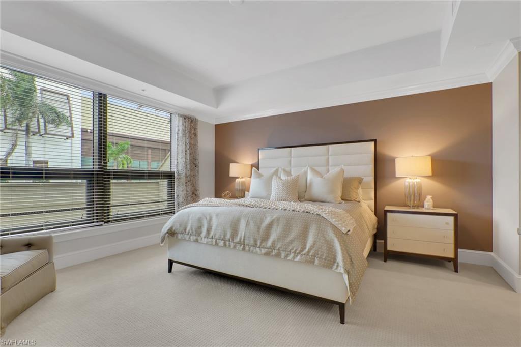 9123 Strada Place, Unit 7216 Naples, FL 34108 - Photo 9 of 28 Carpeted bedroom with baseboards and a raised ceiling