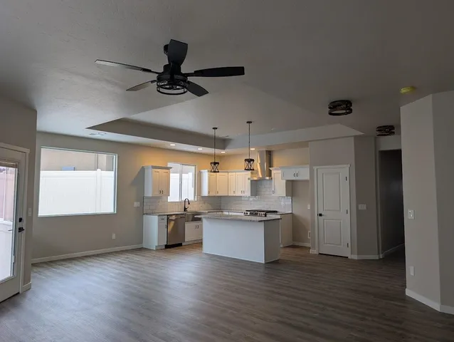 a view of a kitchen with a sink wooden floor and a window