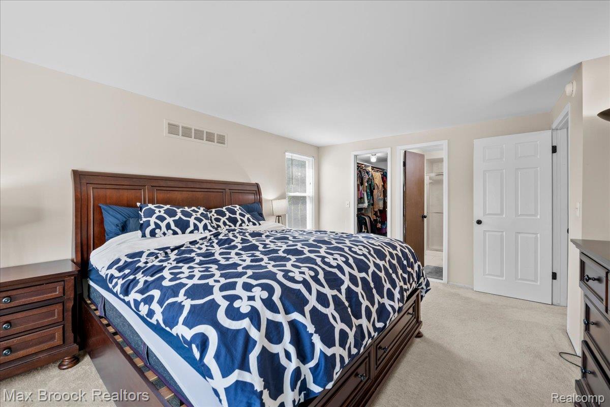 42470 Bishop Road Canton, MI 48188 - Photo 18 of 37 Soft neutral wall color, light-colored carpet flooring, white paneled doors, and natural light from a window