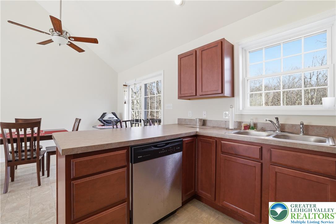 112 Amos Circle Bushkill, PA 18324 - Photo 12 of 52 a kitchen with a sink window and cabinets