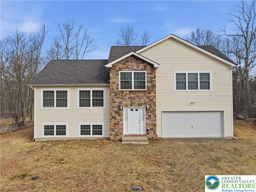 112 Amos Circle Bushkill, PA 18324 - Photo 2 of 52 a front view of a house with a yard and garage