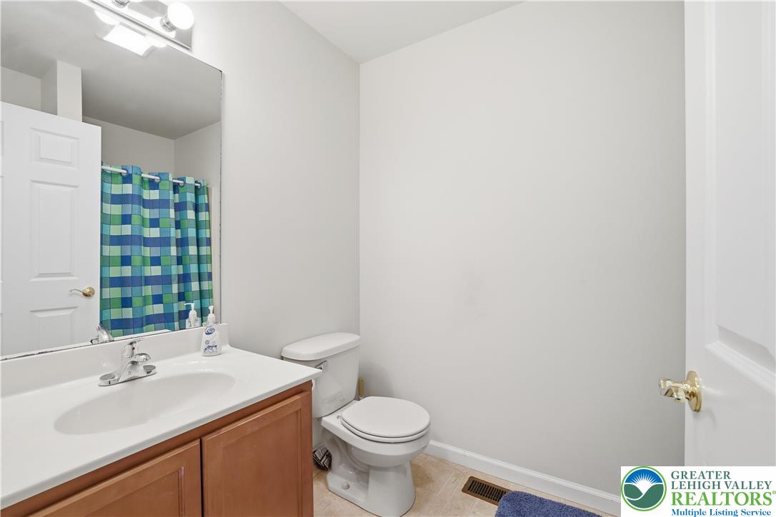 112 Amos Circle Bushkill, PA 18324 - Photo 25 of 52 a bathroom with a sink a toilet and a mirror