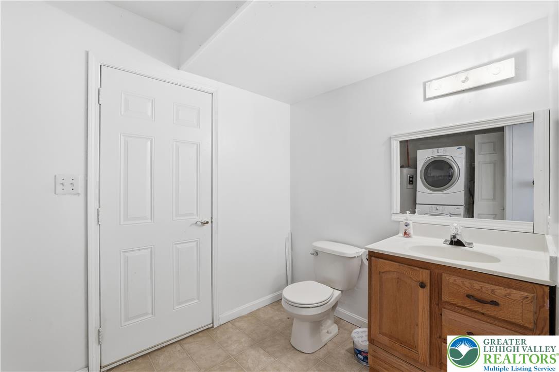 112 Amos Circle Bushkill, PA 18324 - Photo 28 of 52 a bathroom with a toilet a sink a mirror and vanity