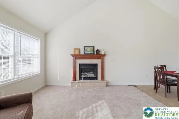 a view of a dining room with furniture and a window