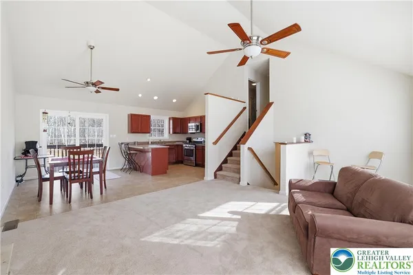 a kitchen with stainless steel appliances granite countertop a stove a sink a refrigerator and a microwave