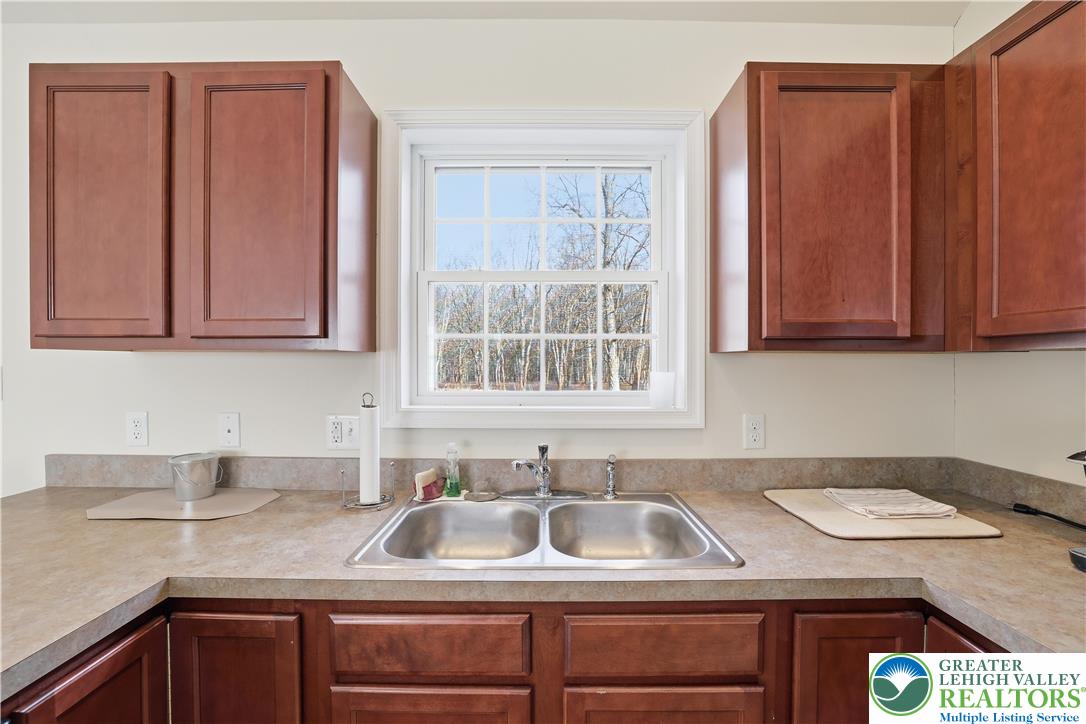 112 Amos Circle Bushkill, PA 18324 - Photo 10 of 52 a kitchen with stainless steel appliances granite countertop a sink and a cabinets