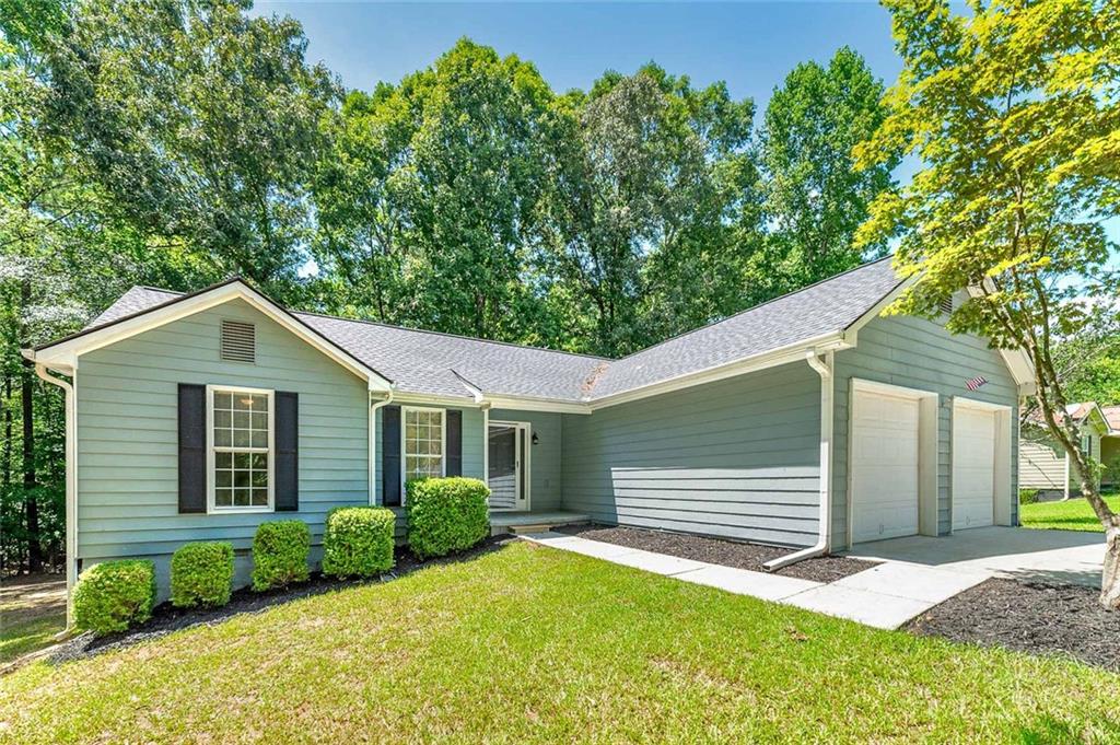 a view of backyard of house with green space
