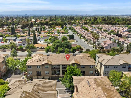 an aerial view of residential houses with city view