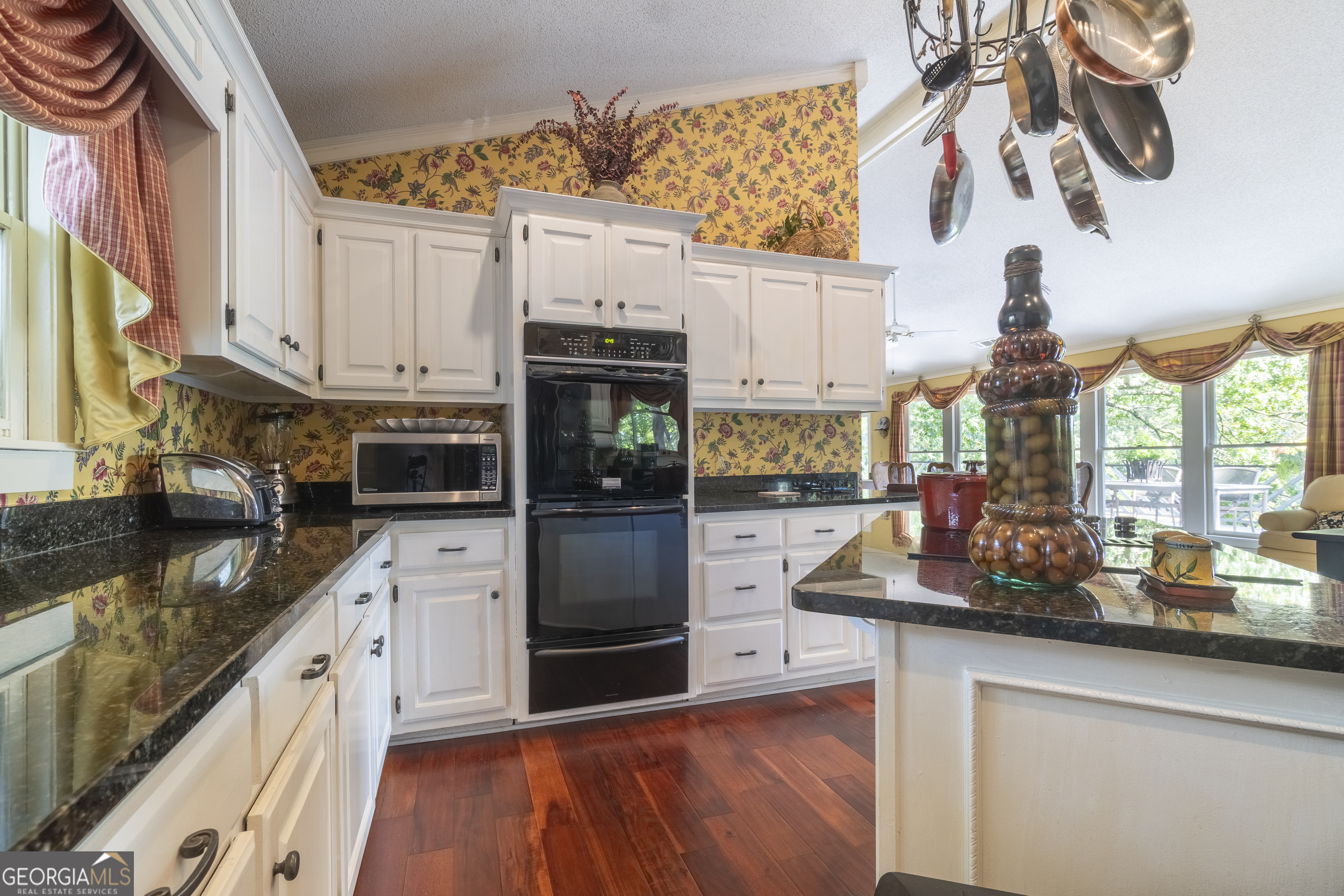 1280 Bahn Innsbruck Helen, GA 30545 - Photo 41 of 85 a kitchen with kitchen island granite countertop a sink cabinets stainless steel appliances and a counter space