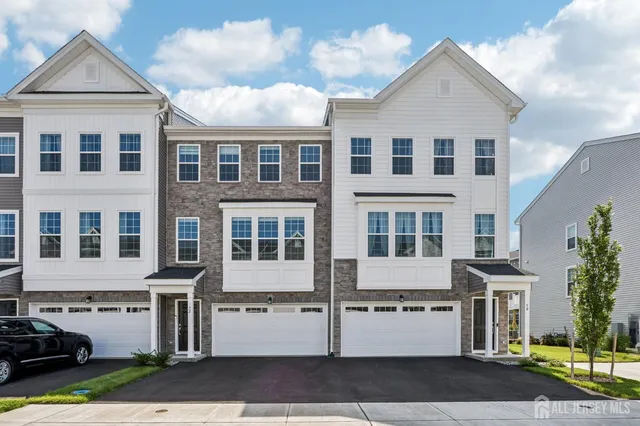 a front view of a residential houses with yard