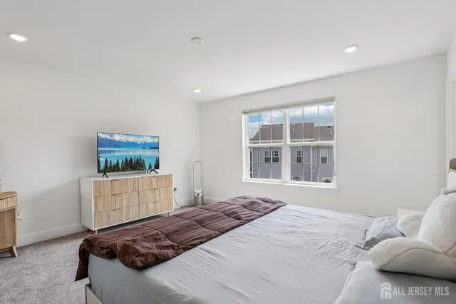 a bedroom with furniture and flat screen tv