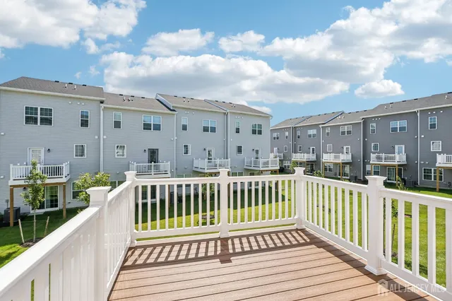 a view of a house with wooden deck