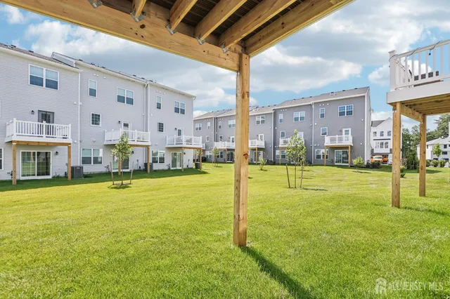 a view of an house with backyard space and balcony