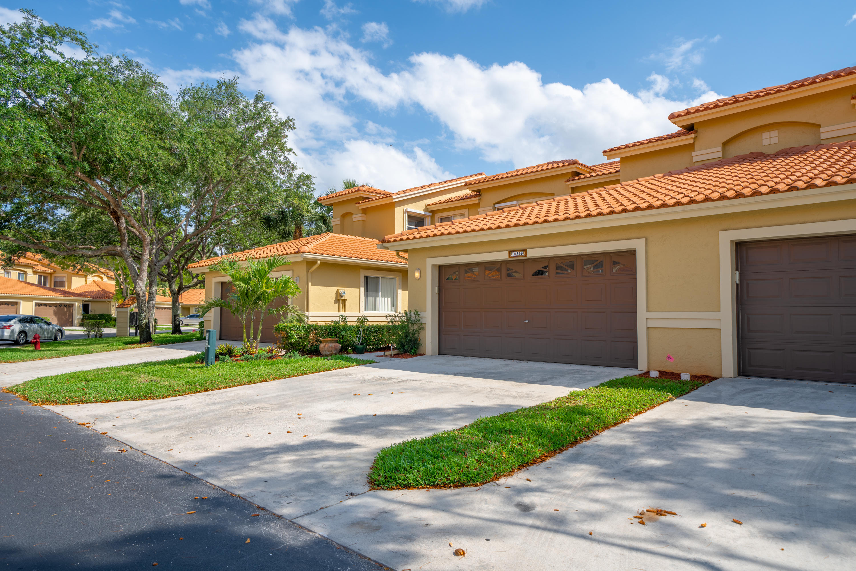 10399 Lake Vista Circle Boca Raton, FL 33498 - Photo 1 of 18 a front view of a house with a yard and garage