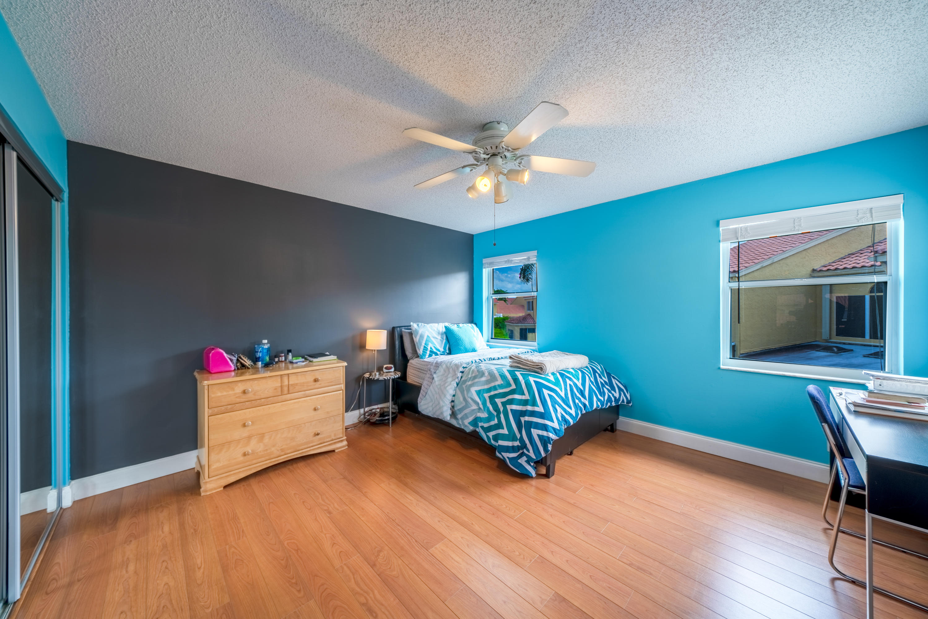10399 Lake Vista Circle Boca Raton, FL 33498 - Photo 13 of 18 a bedroom with a bed and a chandelier