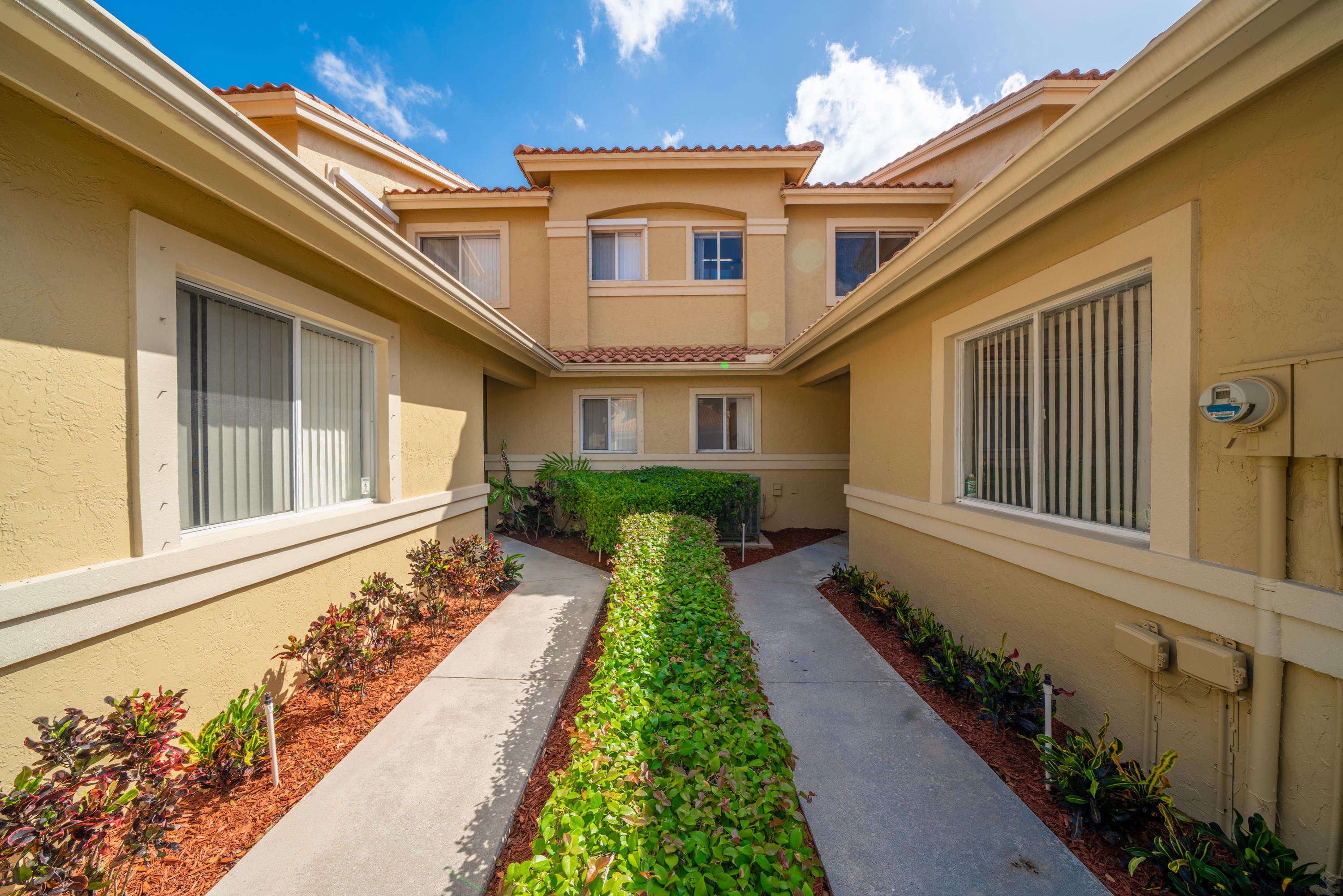 10399 Lake Vista Circle Boca Raton, FL 33498 - Photo 17 of 18 a front view of a house with a yard