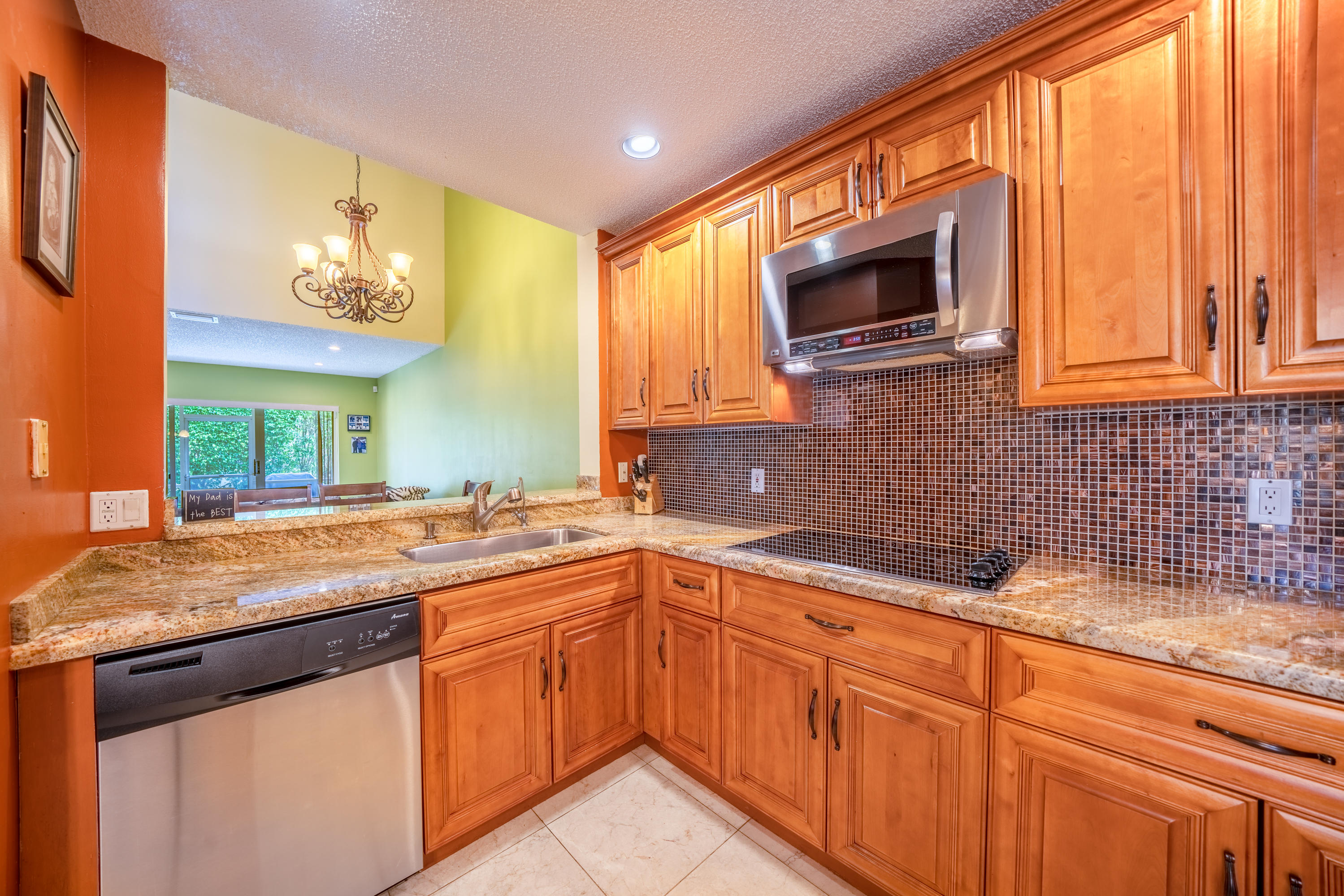 10399 Lake Vista Circle Boca Raton, FL 33498 - Photo 2 of 18 a kitchen with stainless steel appliances granite countertop a sink and a microwave