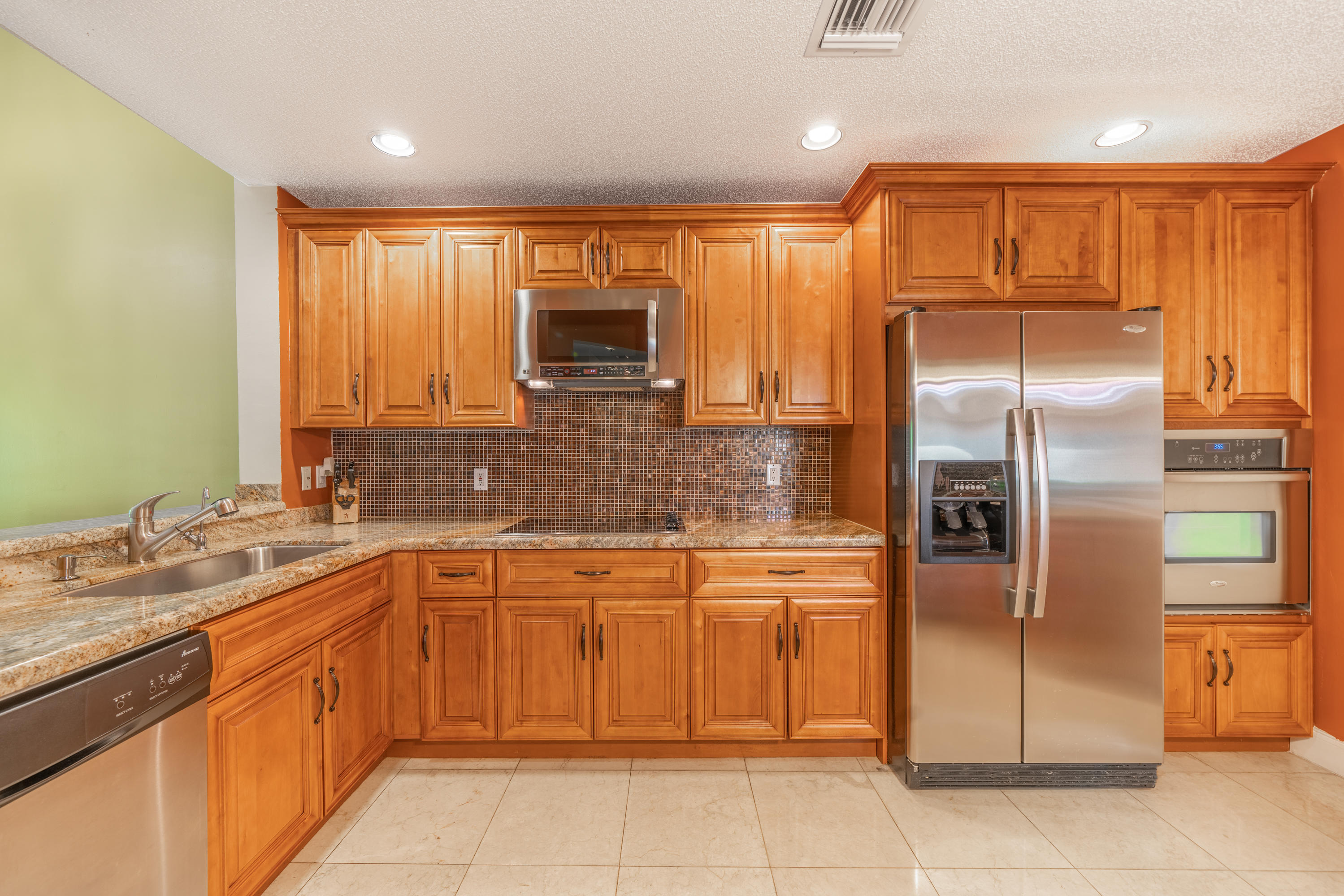 10399 Lake Vista Circle Boca Raton, FL 33498 - Photo 4 of 18 a kitchen with stainless steel appliances granite countertop a refrigerator and a sink