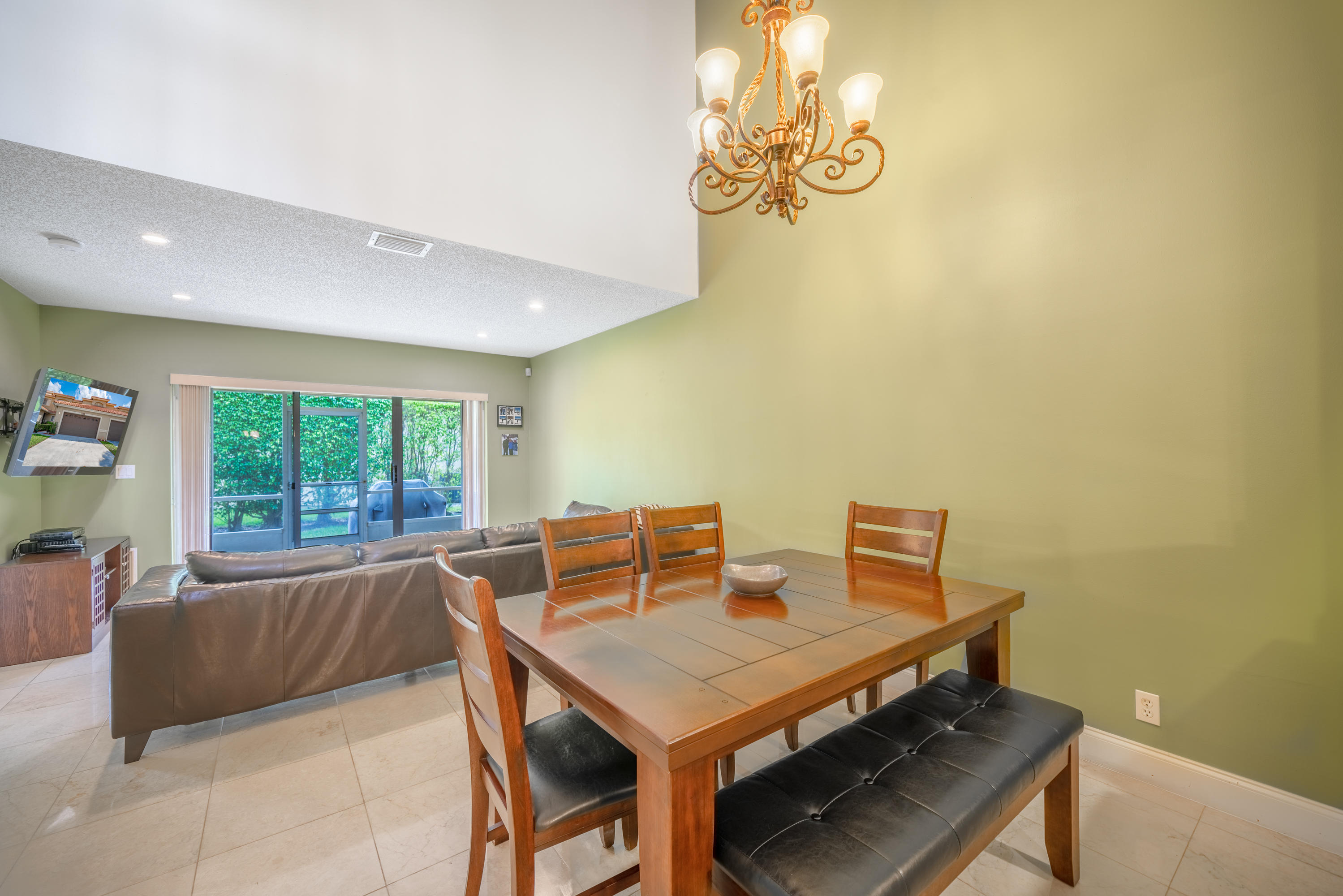 10399 Lake Vista Circle Boca Raton, FL 33498 - Photo 6 of 18 a view of a dining room with furniture a chandelier and a window