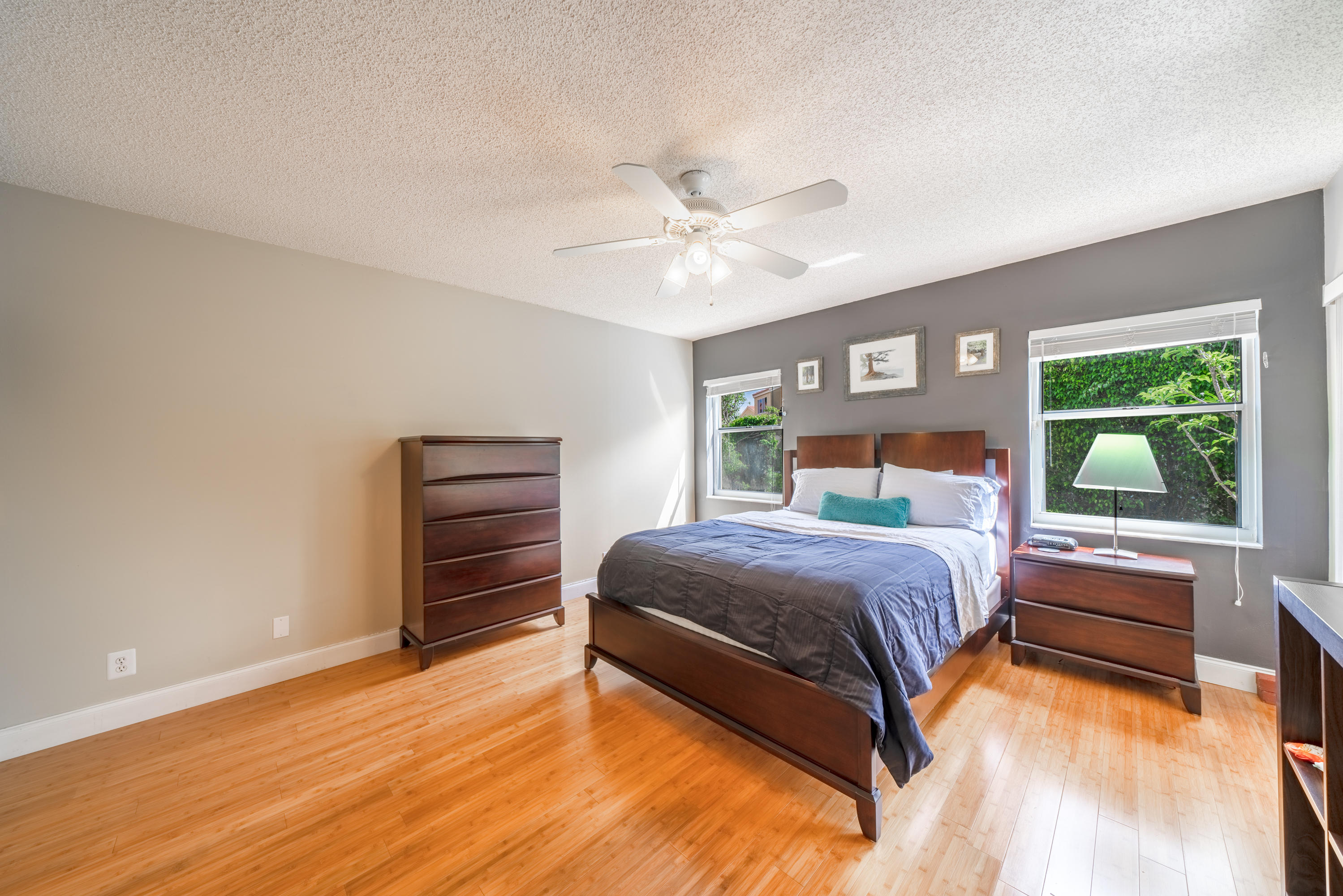 10399 Lake Vista Circle Boca Raton, FL 33498 - Photo 7 of 18 a bedroom with a bed and a ceiling fan