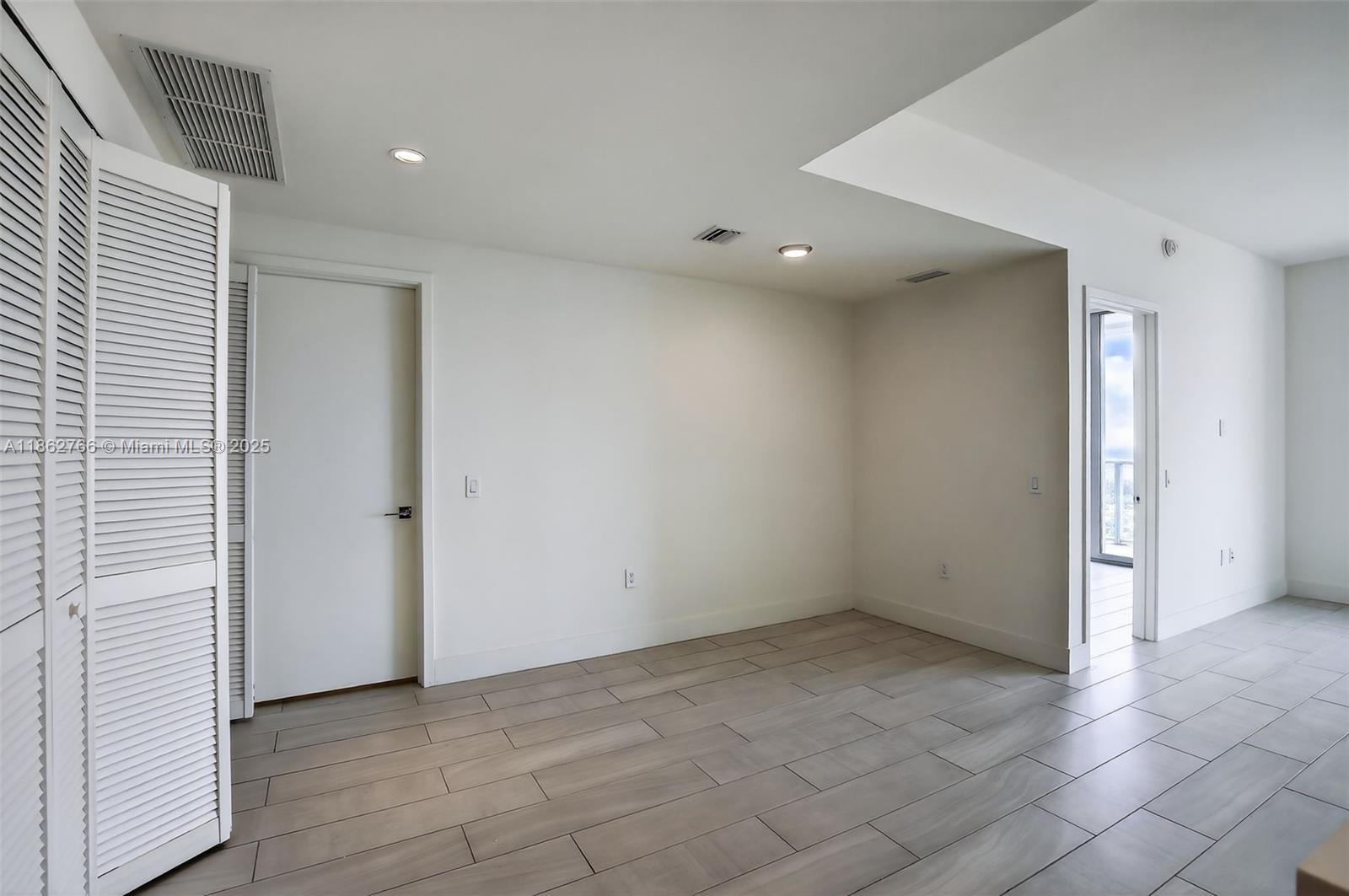 2000 Metropica Way, Unit 2302 Sunrise, FL 33323 - Photo 3 of 34 an empty room with a bathroom