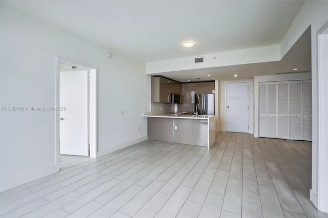 a view of a kitchen with wooden floor and a sink