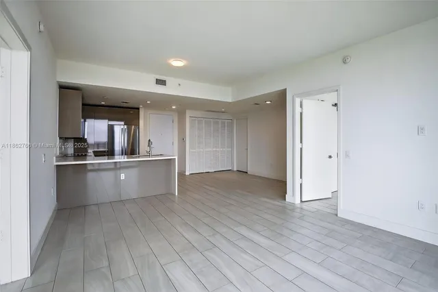 a view of kitchen with refrigerator sink and wooden floor