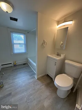 a bathroom with a toilet a sink and vanity