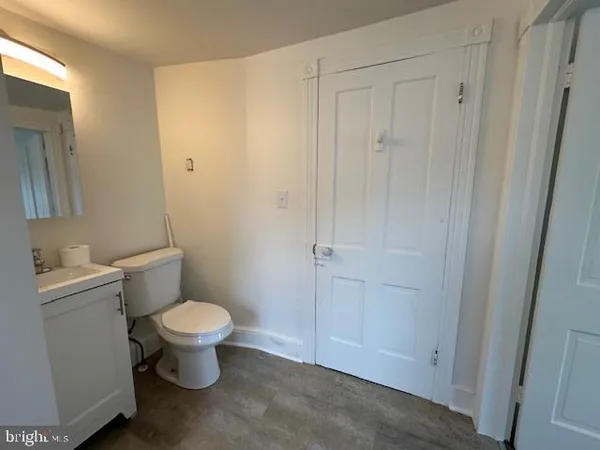 a bathroom with a toilet sink and a mirror