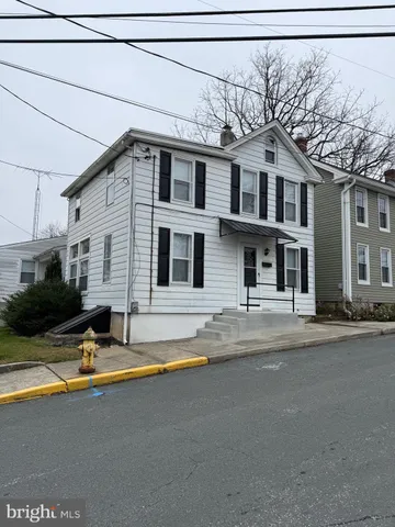 a view of a house with pool and a yard