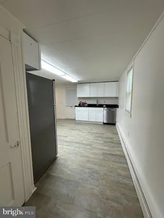 a view of kitchen with refrigerator and window
