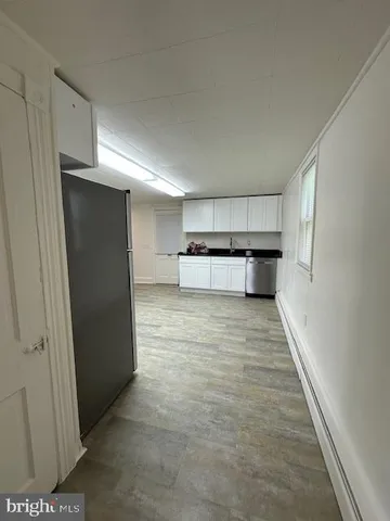 a view of kitchen with refrigerator and window