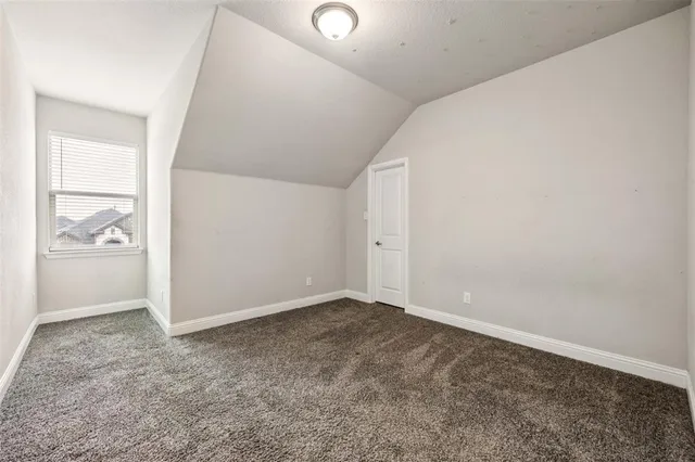 an empty room with sliding door and mirror