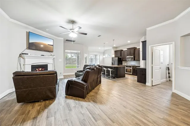 a living room with furniture fireplace and flat screen tv