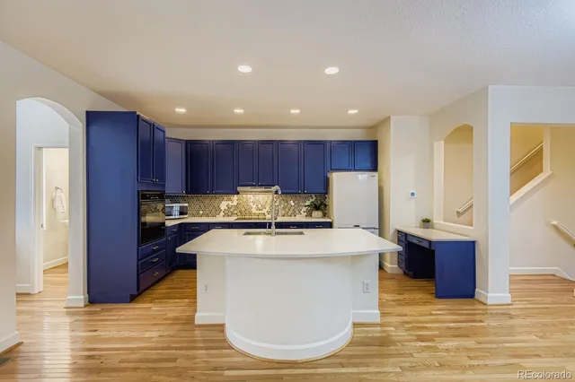 a kitchen with wooden cabinets and center island
